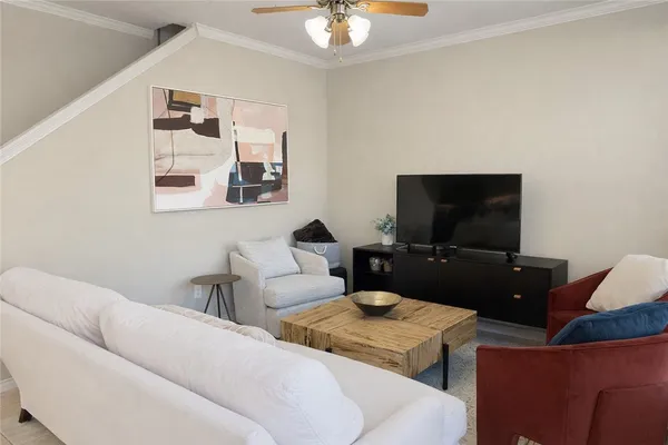 a living room with furniture and a flat screen tv