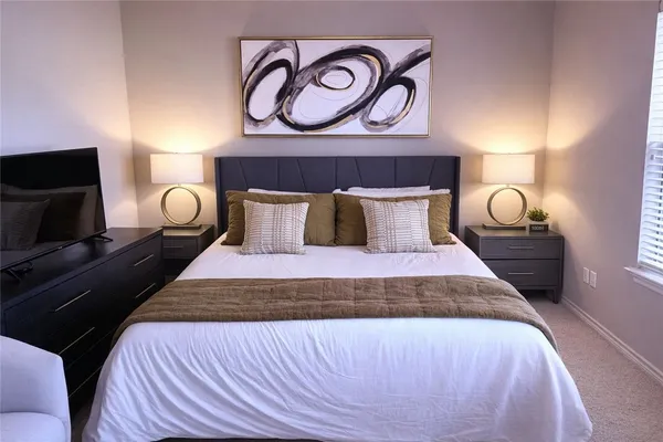 a bedroom with a bed and a lamp