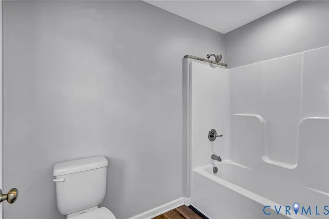 a bathroom with a toilet and a window