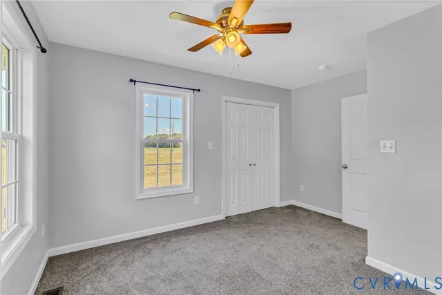a bathroom with a granite countertop sink a toilet and a mirror