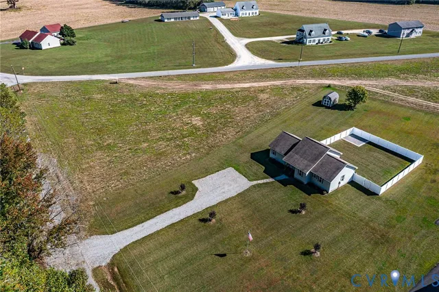 an aerial view of a house with a yard