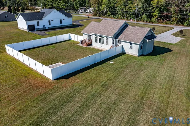 a view of a house with a yard and large trees