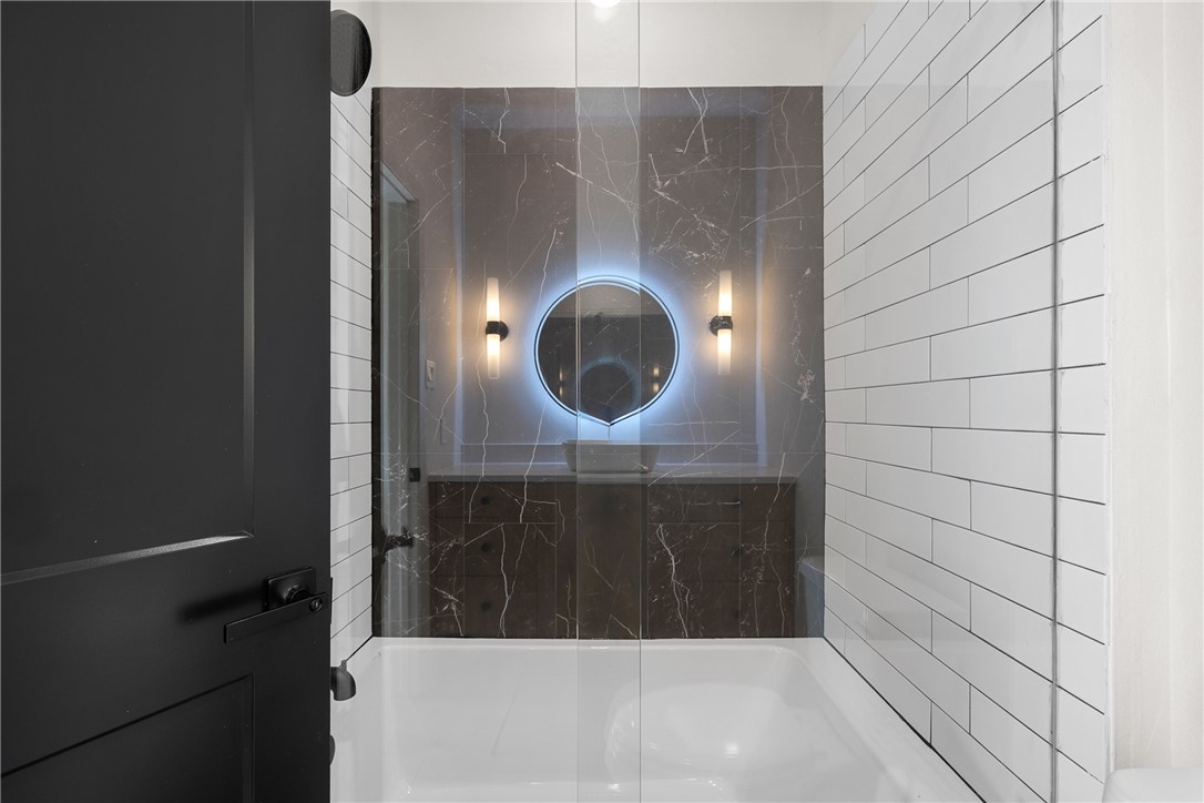 2539 East Villa Maria Road, Unit D Bryan, TX 77802 - Photo 14 of 37 a bathroom with a shower and a mirror