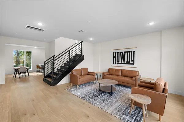 a living room with furniture and a wooden floor