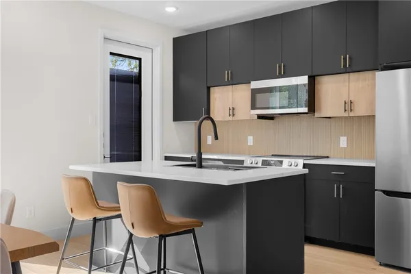 a kitchen with cabinets a sink and appliances