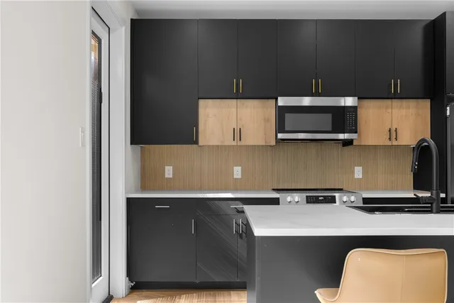 a kitchen with a microwave and cabinets