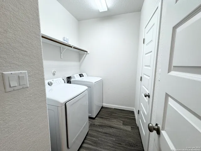 a utility room with cabinets washer and dryer
