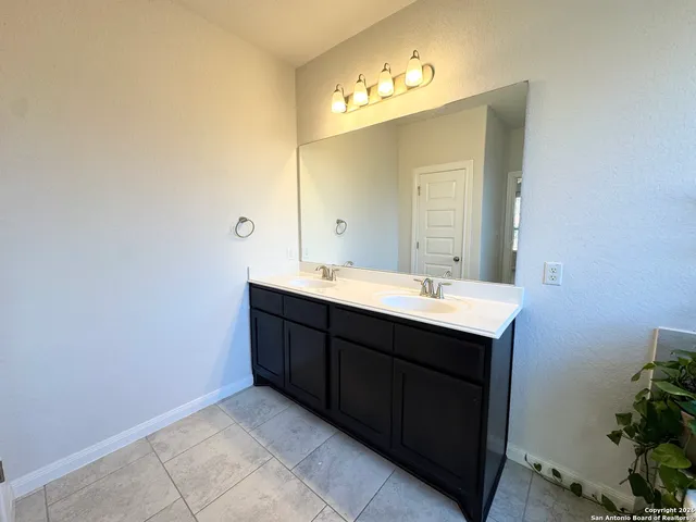 a bathroom with a sink vanity and mirror