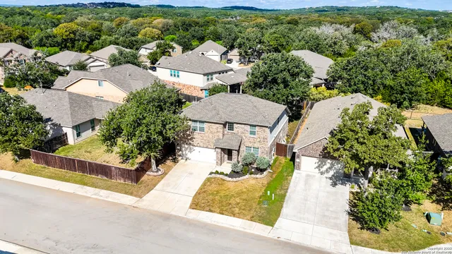 an aerial view of a house with yard