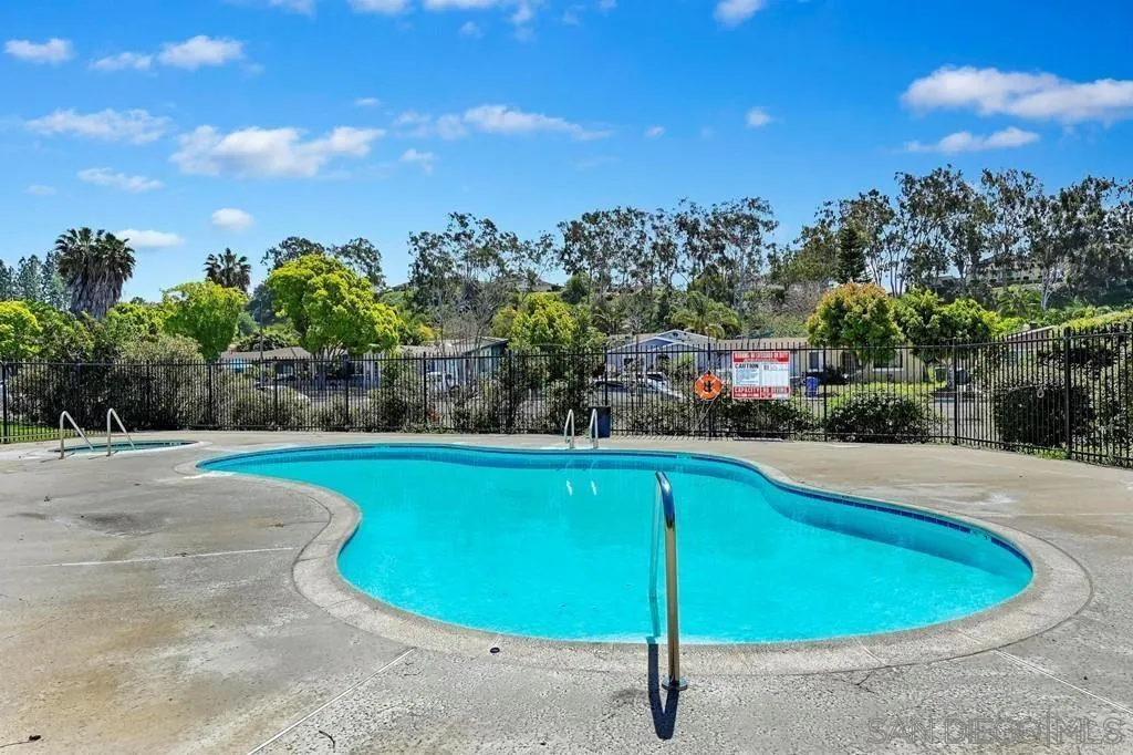 a view of a swimming pool with an outdoor seating and a yard