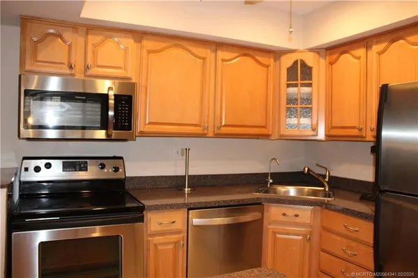 a kitchen with stainless steel appliances a stove and a microwave