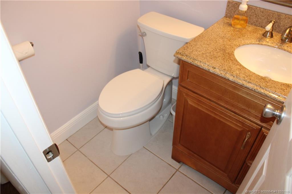 2600 South Kanner Highway, Unit G3 Stuart, FL 34994 - Photo 6 of 13 a bathroom with a granite countertop toilet and sink
