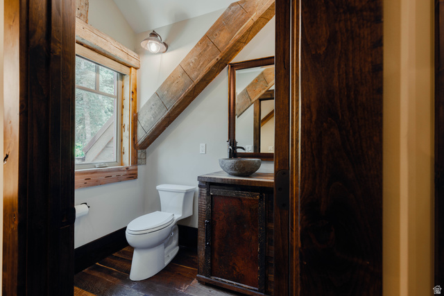 1667 West Tollgate Cyn Road Coalville, UT 84017 - Photo 32 of 61 Powder room featuring a stone vessel sink, dark wood-finish vanity with an integrated mirror, and exposed wood beam accents