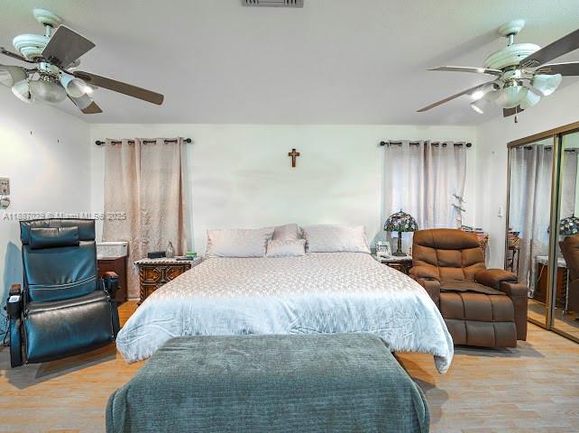 14220 Southwest 109th Street Miami, FL 33186 - Photo 11 of 30 a bedroom with a bed and ceiling fan