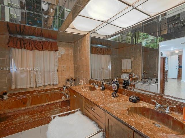 14220 Southwest 109th Street Miami, FL 33186 - Photo 12 of 30 a bathroom with a granite countertop tub and a sink