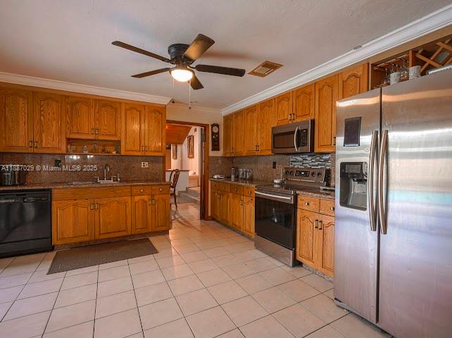 14220 Southwest 109th Street Miami, FL 33186 - Photo 14 of 30 a kitchen with stainless steel appliances granite countertop a stove top oven a sink a dining table and chairs