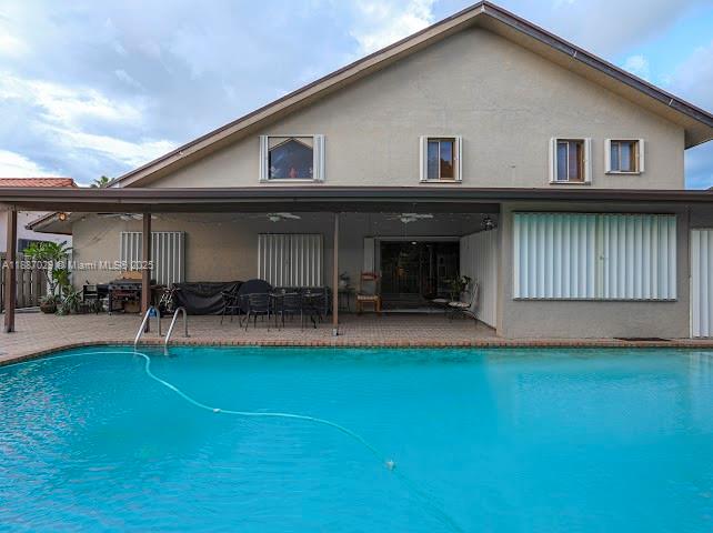 14220 Southwest 109th Street Miami, FL 33186 - Photo 20 of 30 a view of a house with patio and a garden