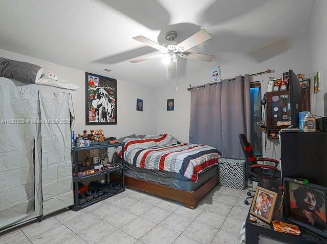 14220 Southwest 109th Street Miami, FL 33186 - Photo 6 of 30 a bedroom with a bed and a refrigerator