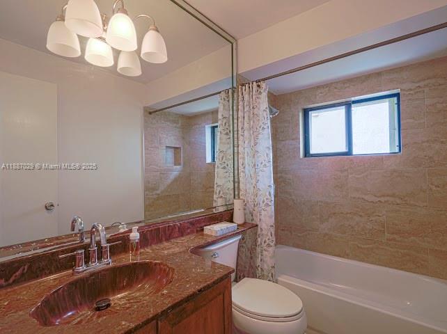 14220 Southwest 109th Street Miami, FL 33186 - Photo 7 of 30 a bathroom with a sink a toilet a mirror a bathtub and shower