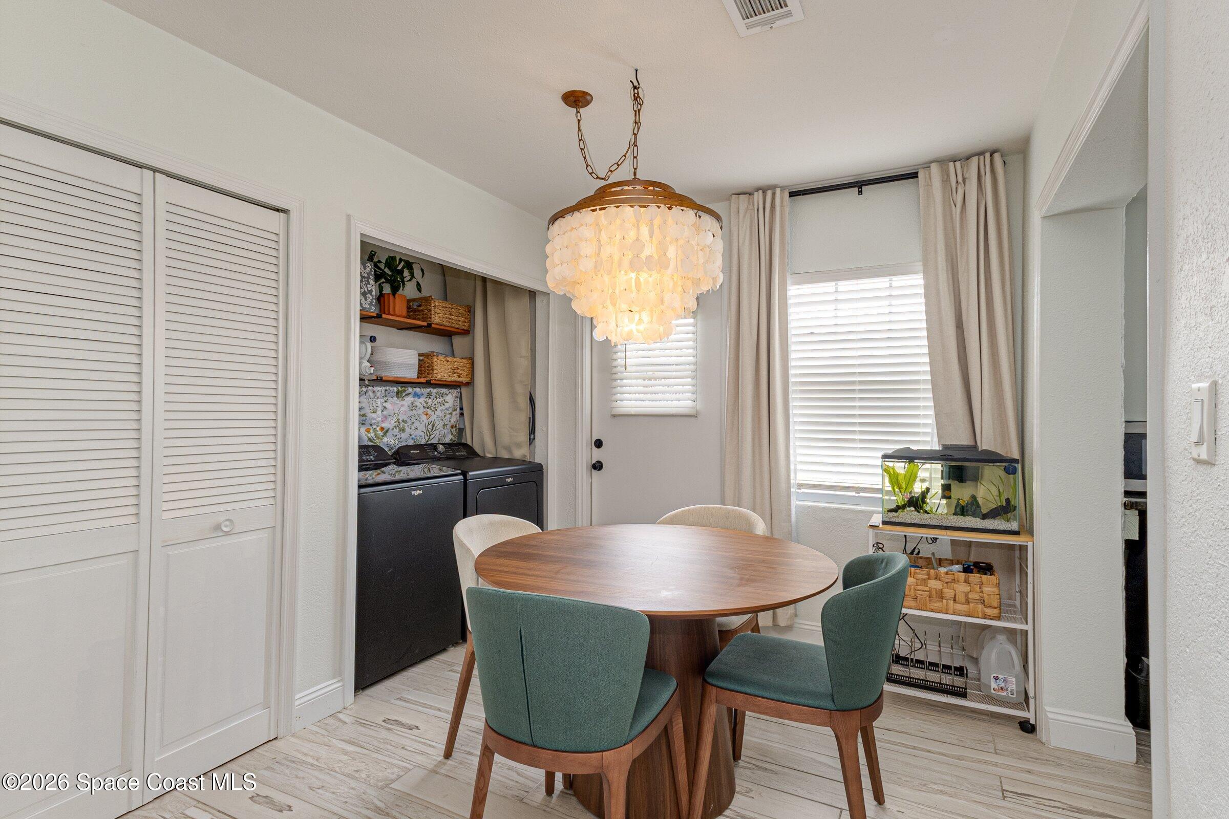 131 Delmar Street Indialantic, FL 32903 - Photo 11 of 29 a view of a dining room with furniture and window
