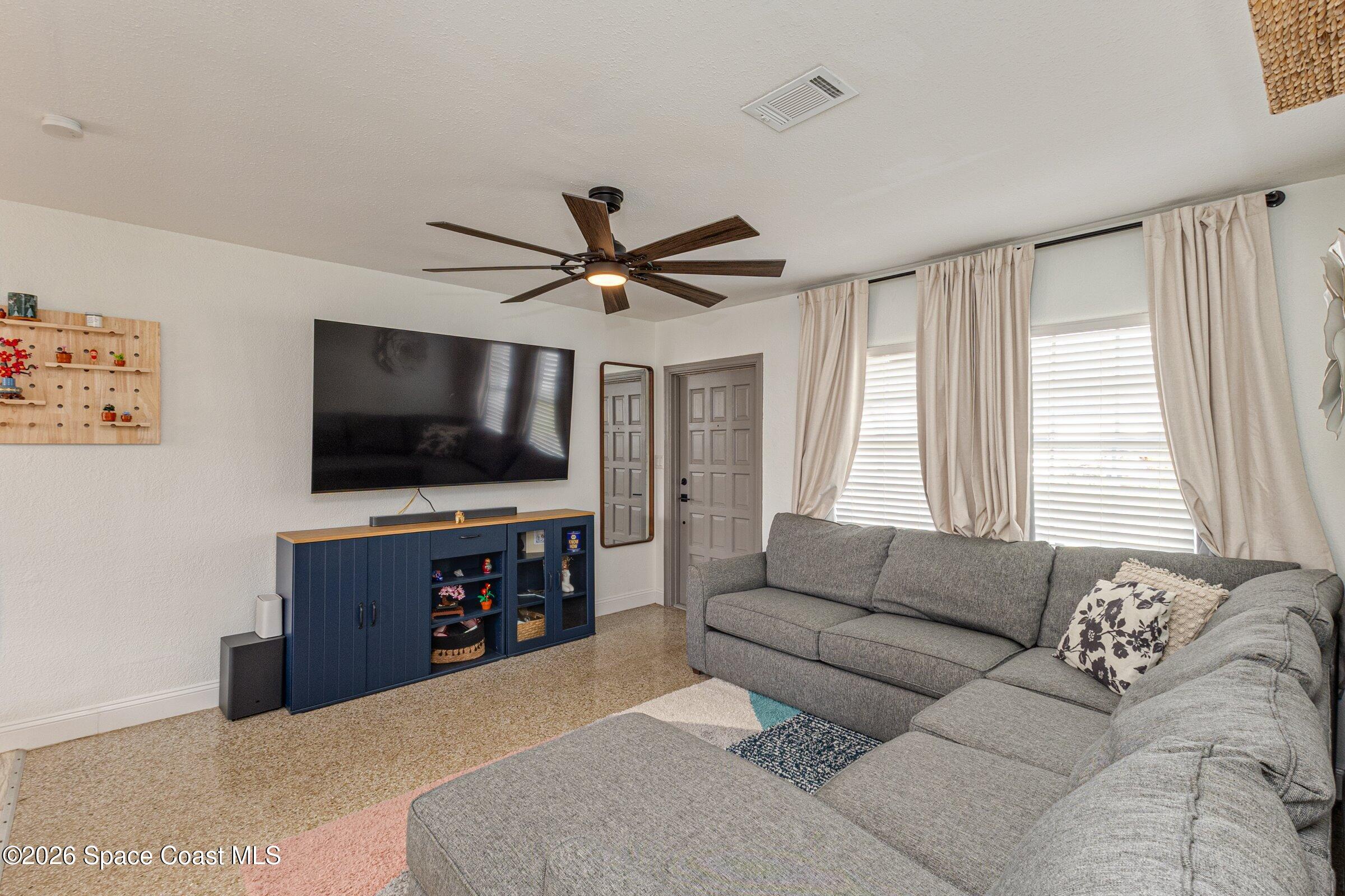 131 Delmar Street Indialantic, FL 32903 - Photo 12 of 29 a living room with furniture and a flat screen tv