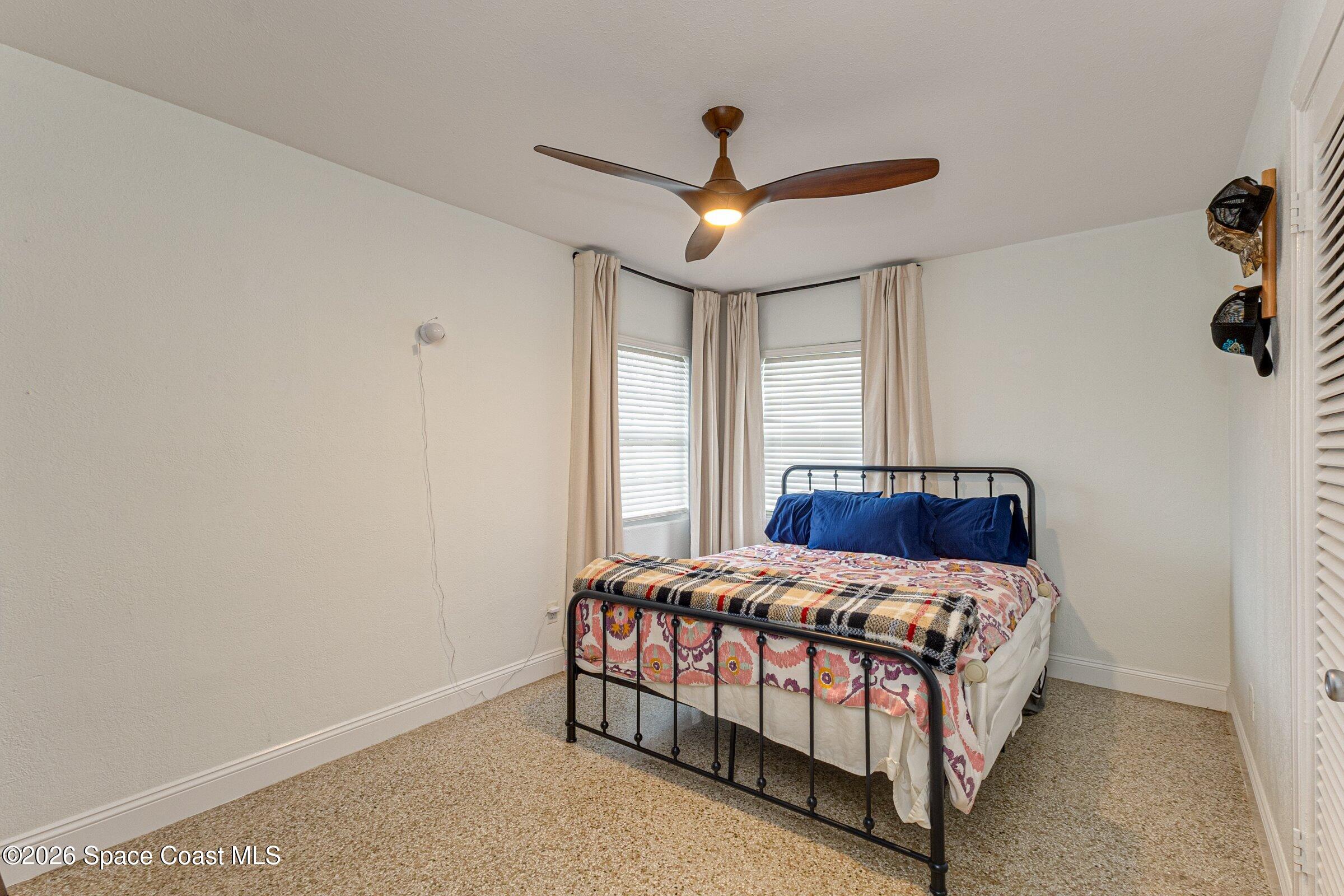 131 Delmar Street Indialantic, FL 32903 - Photo 17 of 29 a bedroom with a bed and window