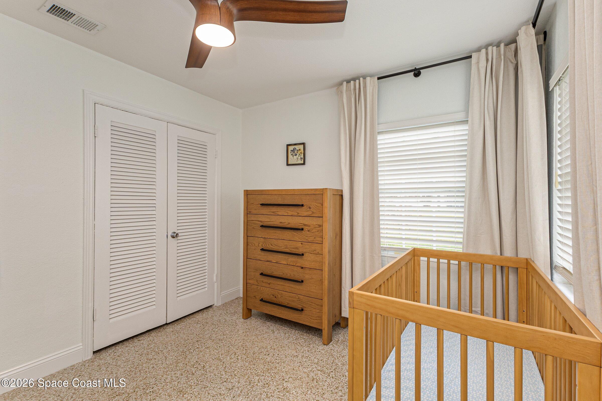 131 Delmar Street Indialantic, FL 32903 - Photo 18 of 29 a view of a bedroom with furniture and window