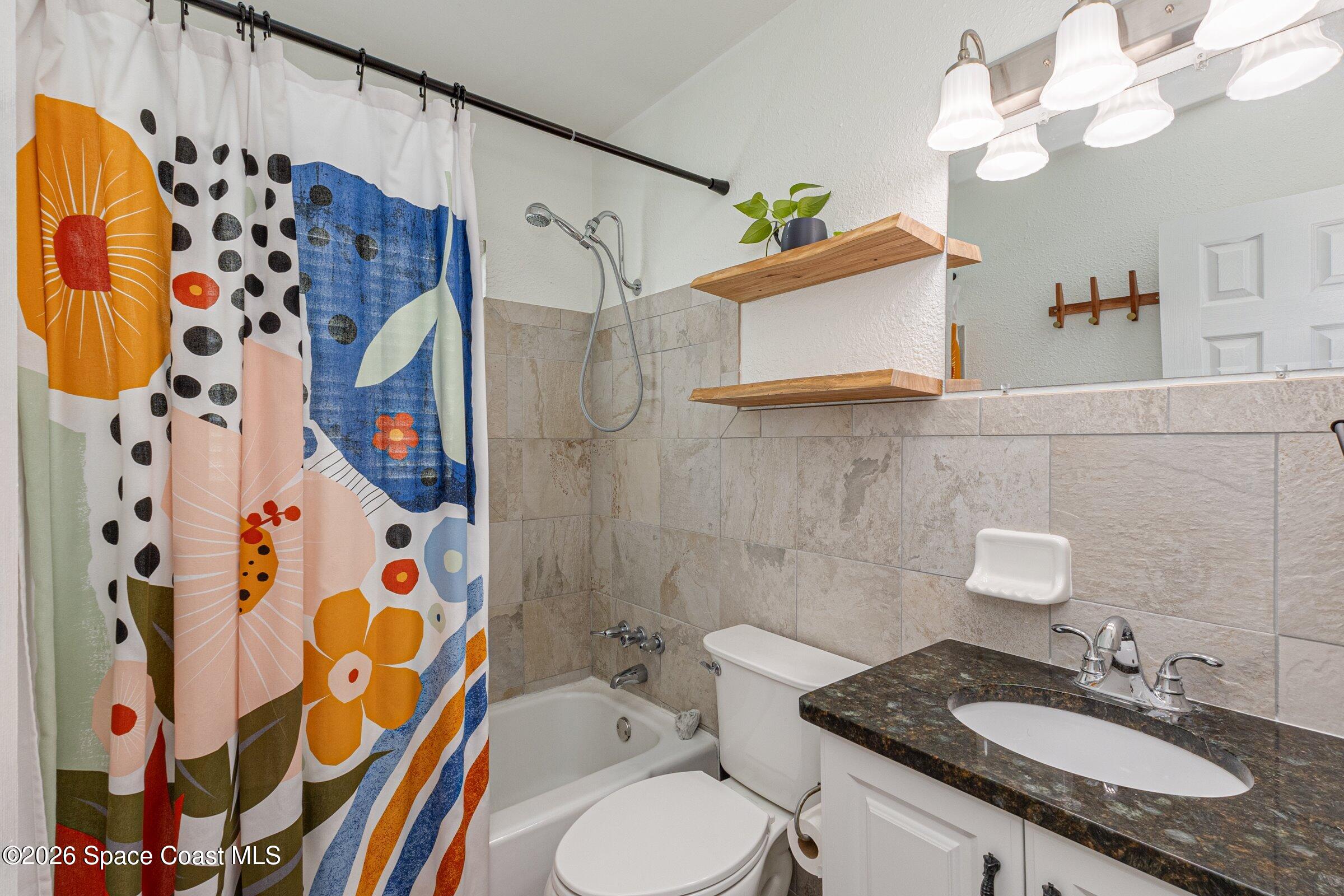 131 Delmar Street Indialantic, FL 32903 - Photo 20 of 29 a bathroom with a sink vanity granite and toilet