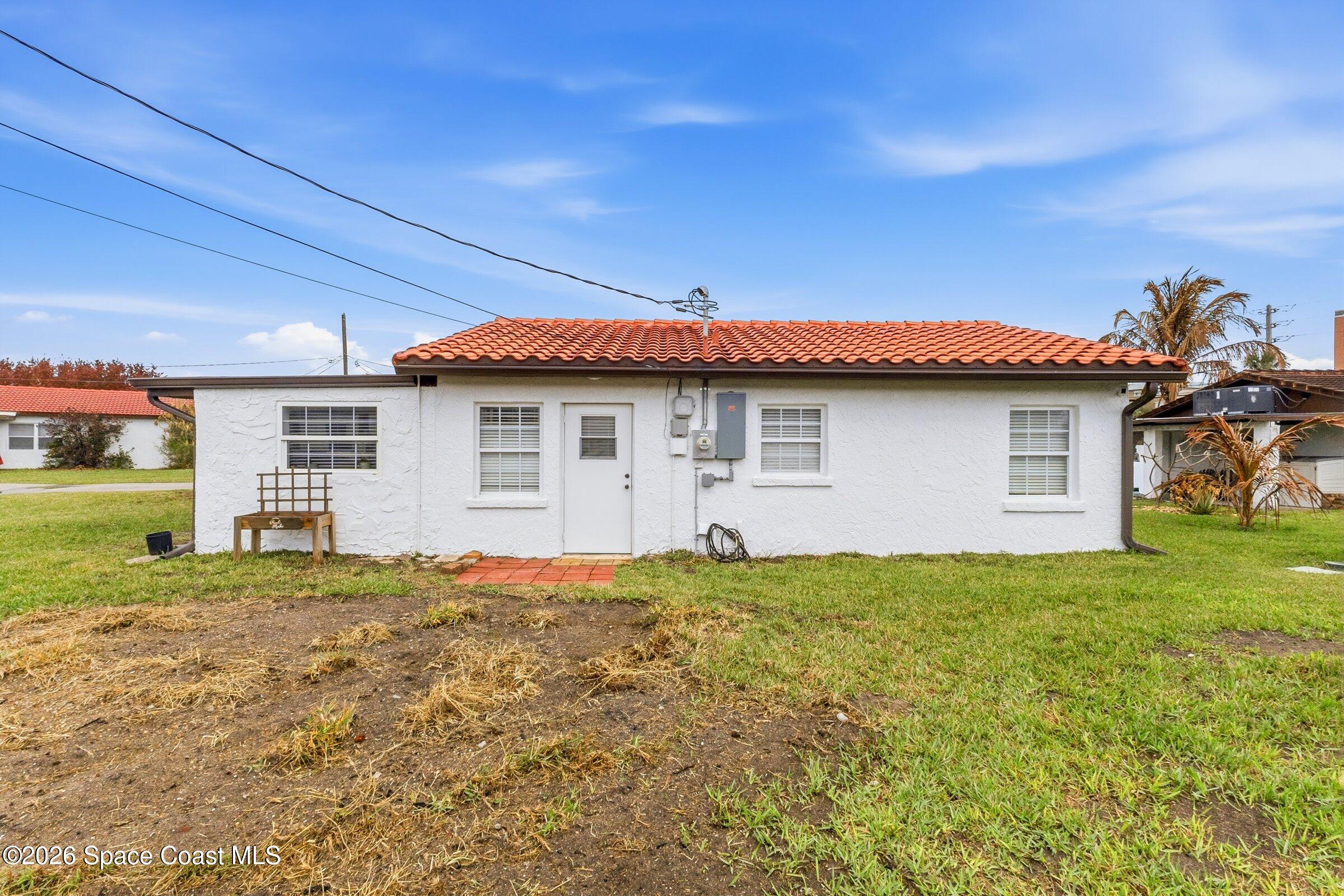131 Delmar Street Indialantic, FL 32903 - Photo 22 of 29 a view of a house with a backyard