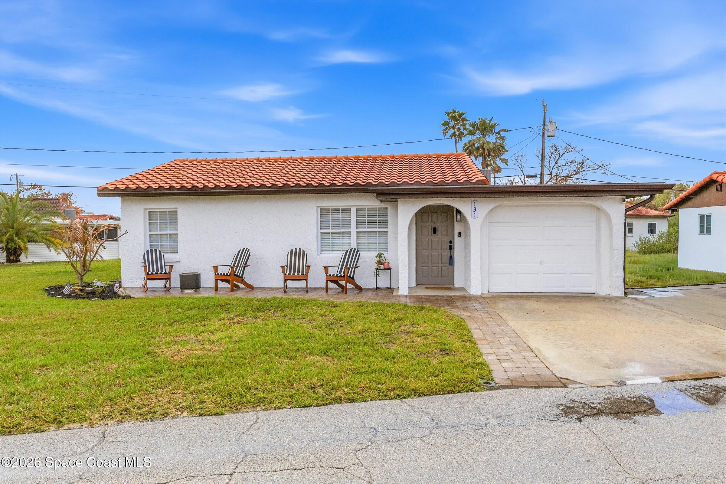 131 Delmar Street Indialantic, FL 32903 - Photo 3 of 29 a front view of a house with garden