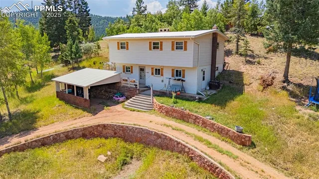 a aerial view of a house with a yard balcony and swimming pool