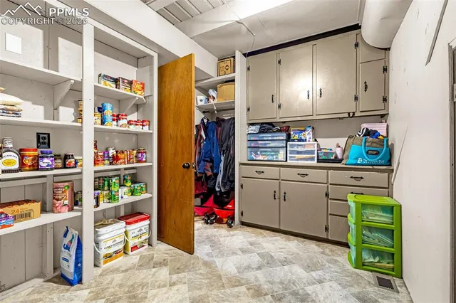 a room with refrigerator and cabinets