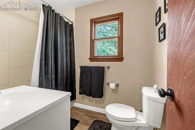 a bathroom with a toilet a sink and a mirror