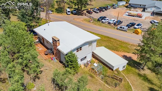 an aerial view of a house with a yard