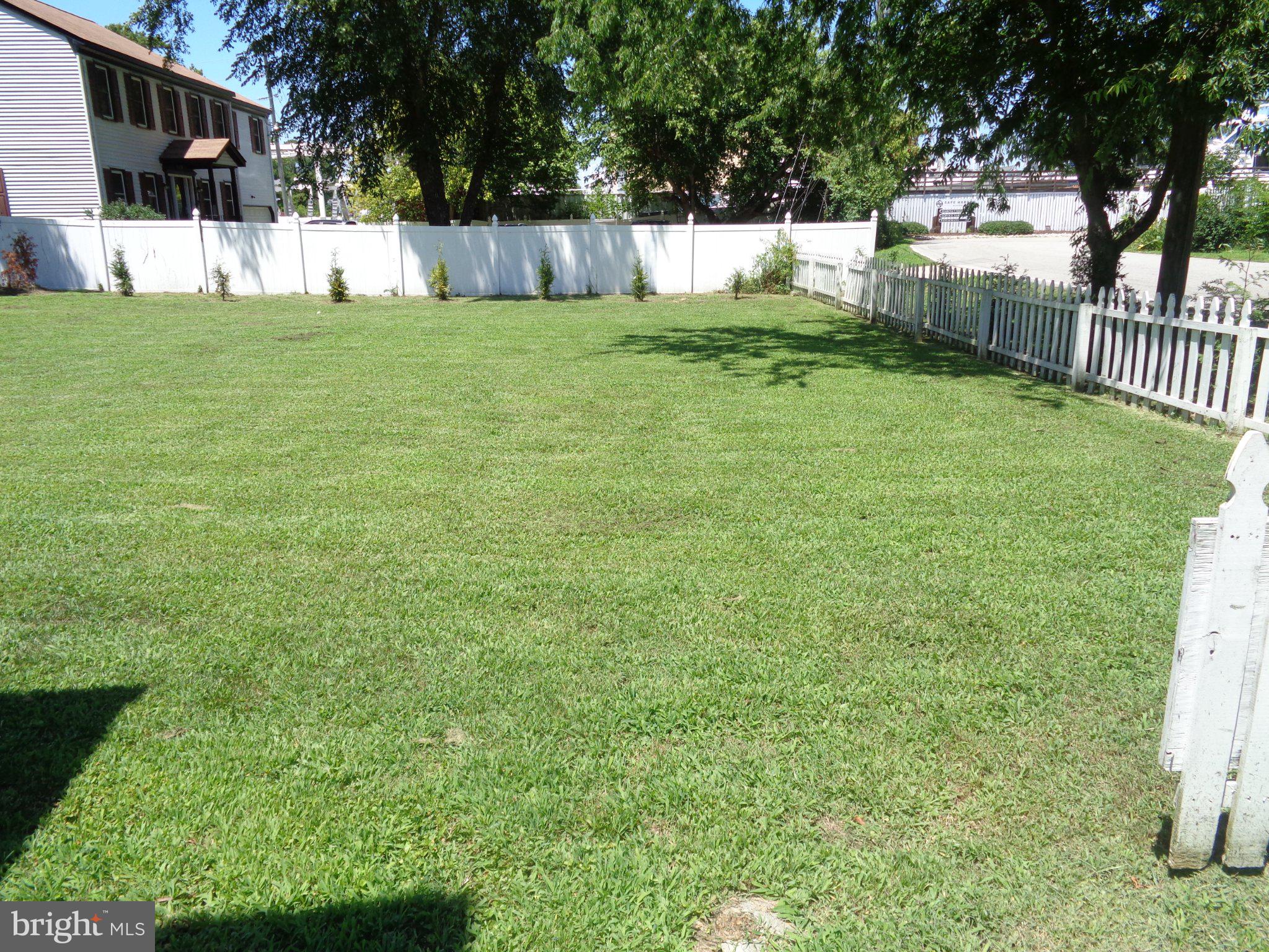56 Ivy Home Road Hampton, VA 23669 - Photo 31 of 35 Spacious green yard with white fence.