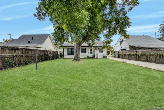 a front view of a house with a yard table and chairs