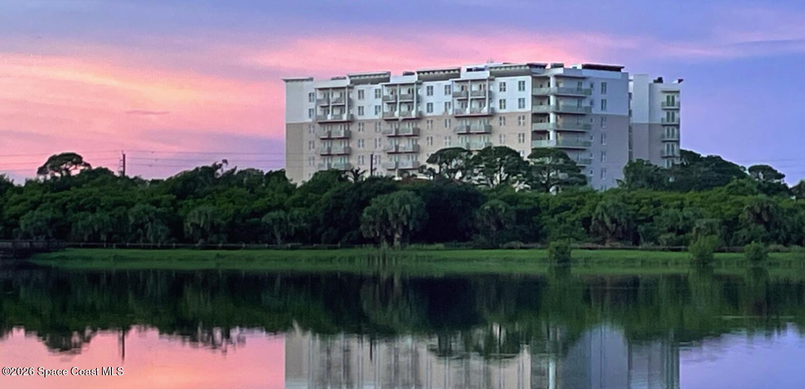 735 Pilot Lane, Unit 503 Merritt Island, FL 32952 - Photo 11 of 26 a view of a lake with a building in front of it
