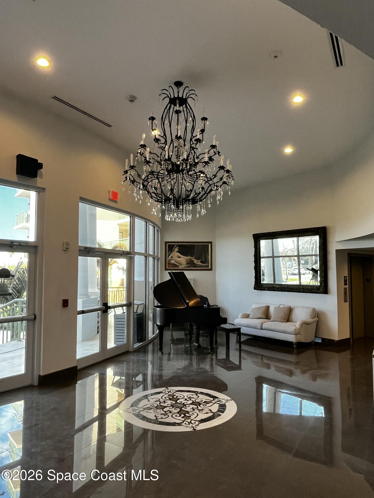 735 Pilot Lane, Unit 503 Merritt Island, FL 32952 - Photo 13 of 26 a living room with furniture a rug a chandelier and a table