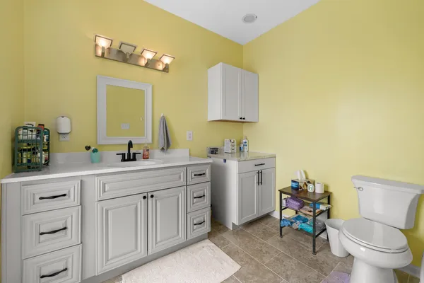 a spacious bathroom with a double vanity sink and a toilet