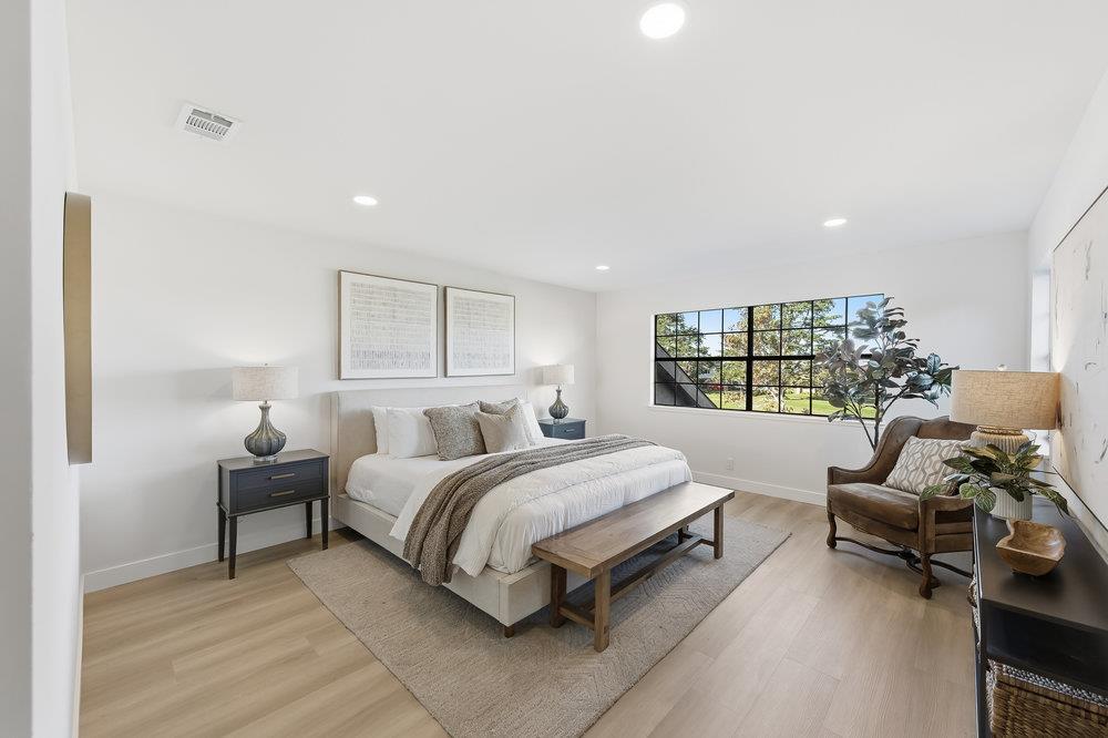 370 Burning Tree Court Half Moon Bay, CA 94019 - Photo 19 of 47 a spacious bedroom with a bed and a couch