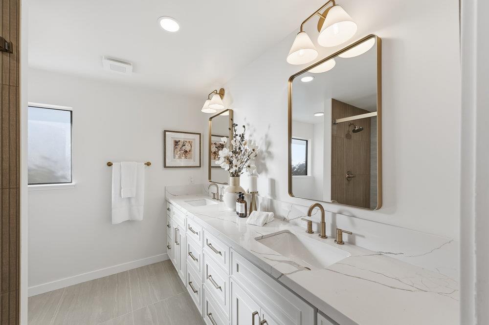 370 Burning Tree Court Half Moon Bay, CA 94019 - Photo 24 of 47 a bathroom with double vanity sinks and a mirror