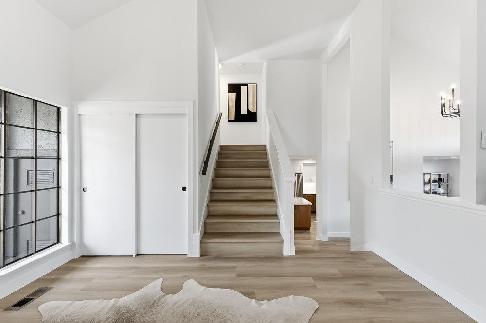 370 Burning Tree Court Half Moon Bay, CA 94019 - Photo 26 of 47 a view of a livingroom with wooden floor and stairs