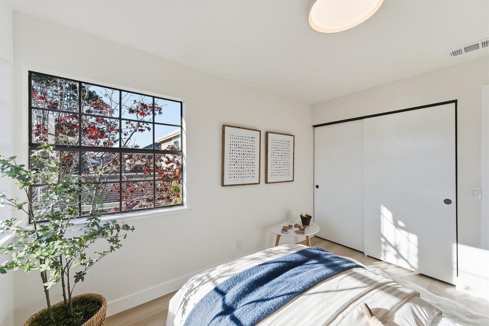 370 Burning Tree Court Half Moon Bay, CA 94019 - Photo 30 of 47 a bedroom with a bed and a potted plant