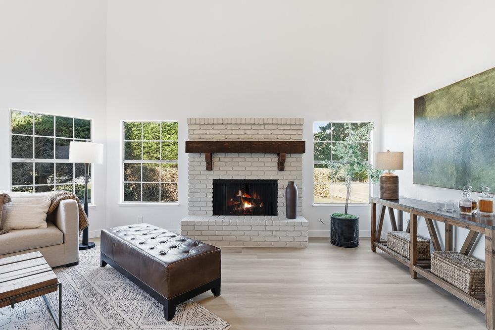370 Burning Tree Court Half Moon Bay, CA 94019 - Photo 4 of 47 a living room with furniture and a fireplace