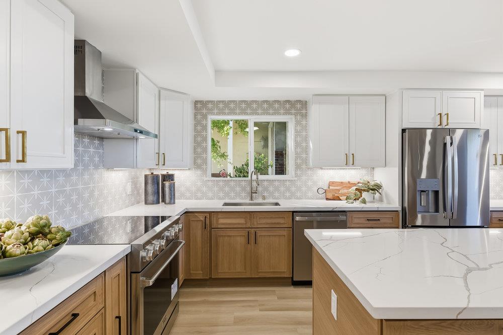 370 Burning Tree Court Half Moon Bay, CA 94019 - Photo 9 of 47 a kitchen with stainless steel appliances granite countertop a sink stove and refrigerator