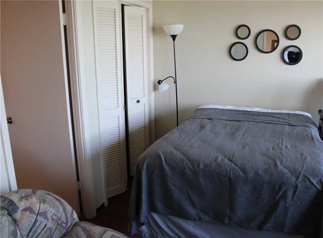 a bedroom with a bed and a mirror