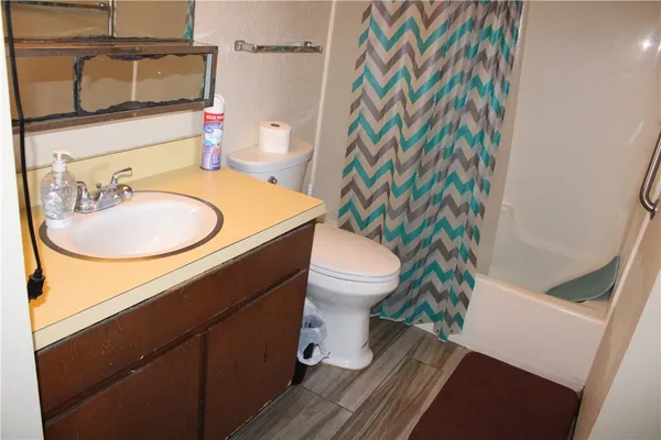 a bathroom with a sink toilet and mirror