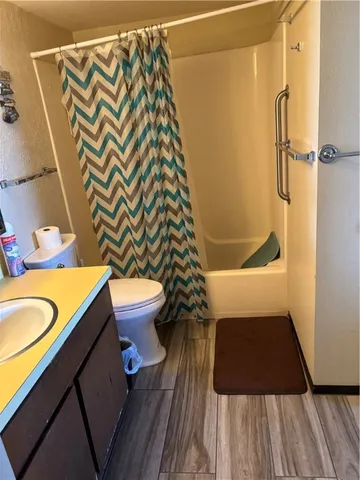 a bathroom with a toilet and a shower curtain