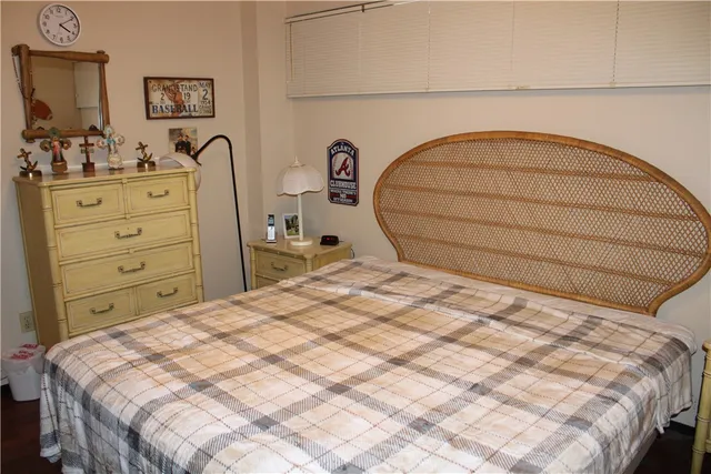 a bedroom with a bed and a dresser