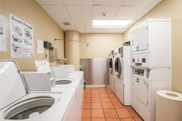 a white kitchen with a sink a washer and dryer
